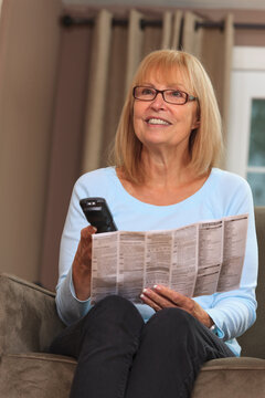 Home owner using instructions to try cable remote