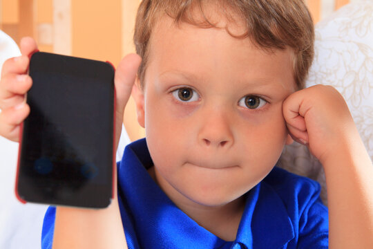 Boy showing off his cell phone