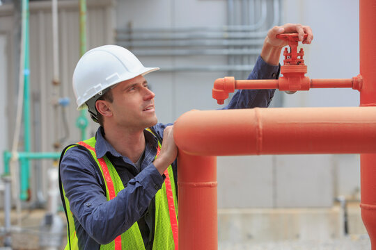 Industrial engineer checking bleed valve at a power plant