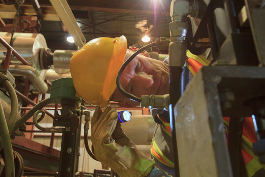 Engineer in electric power plant inspecting a electrically controlled valve