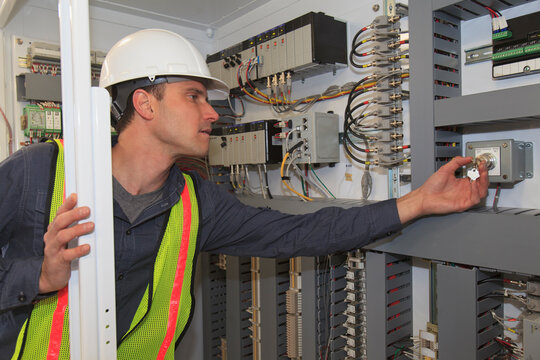 Industrial engineer checking programmable logic controllers at a power plant