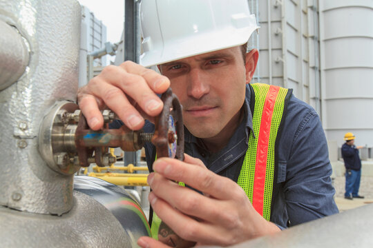 Industrial engineer checking valve corrosion at a power plant