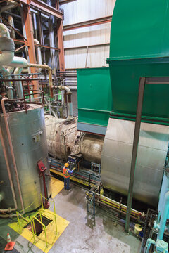 Engineer in gas turbine electric power plant exhaust gas and condensation process room
