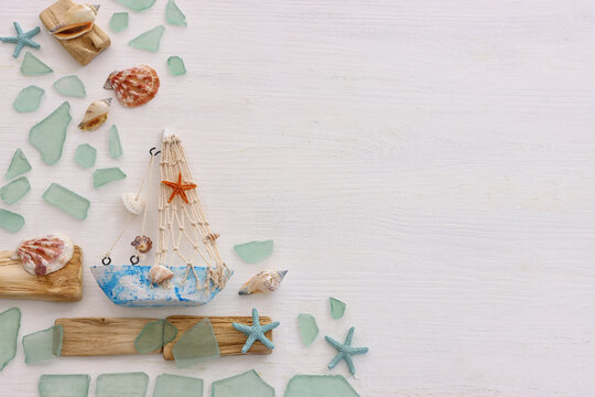 summer background with blue sea glass and shells