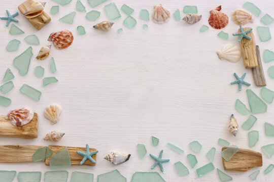 summer background with blue sea glass and shells
