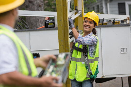 Utility workers looking at the line work on site