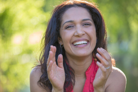 Portrait of happy Hispanic woman smiling in a park