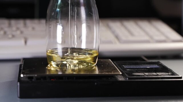 Pouring essential oil into bottle for aroma diffuser liquid