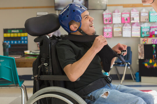 Boy with Spastic Quadriplegic Cerebral Palsy using using his special needs helmet