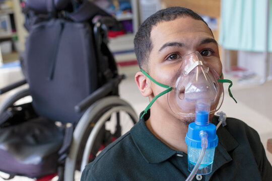 Boy with Spastic Quadriplegic Cerebral Palsy learning at school and using his medical breathing