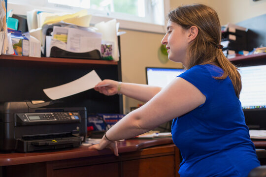 Young Woman with Cerebral Palsy using a printer at home