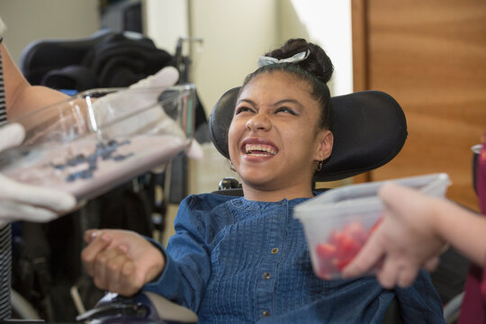 Teen with Spastic Dystonic Cerebral Palsy being fed at school