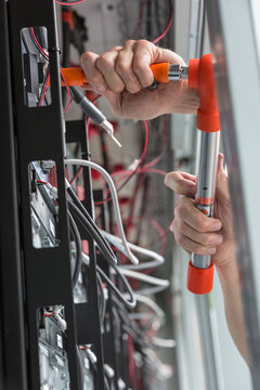 Engineer using a torque wrench on copper bolts