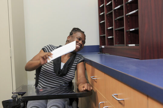 Teen with Cerebral Palsy using mailbox