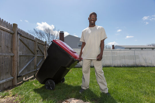 Man with Williams Syndrome taking out the trash