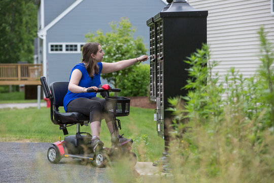 Young Woman with Cerebral Palsy getting the mail