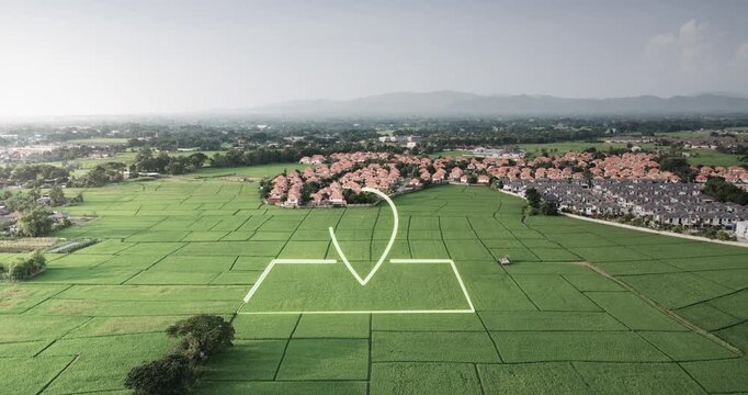 Aerial drone footage of green agricultural land with GPS location marker, boundary outline and village community in background. Property for sale concept featuring land parcel identification.