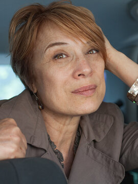 Nice real woman passenger sitting in car closeup portrait