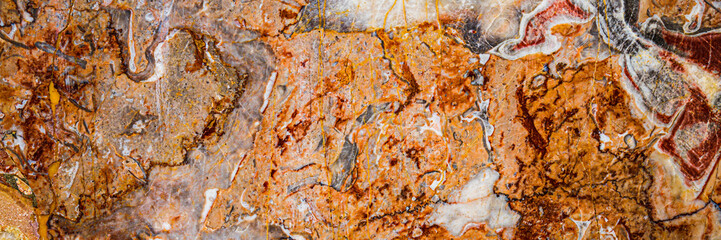 Naklejka premium Natural stone surface with patterns in shades of orange and brown found in a rock formation during the day
