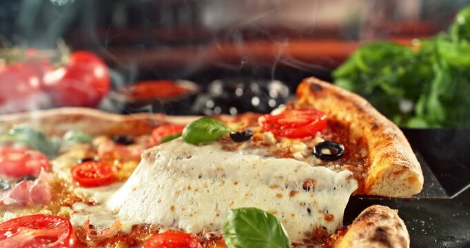 Super slow motion footage (1000 fps) of a pizza slice being lifted with perfectly melted, stretchy cheese. Rich textures of crust, salami, tomato and fresh basil in cinematic light.