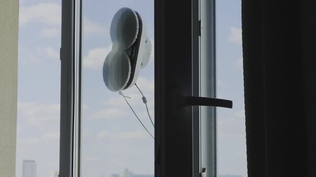 Introducing a high tech robot vacuum cleaner efficiently maintaining the exterior glass of a tall skyscraper. This cutting edge technology simplifies household tasks and upkeep