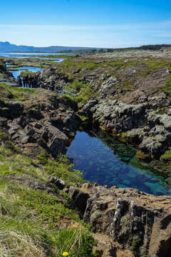 Natural rock formations with a clear water pool in a rugged landscape,Silfra Fissure,ICELAND