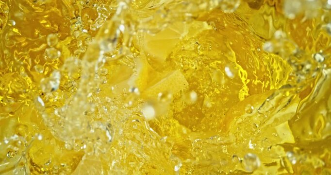 Super slow motion 1000fps video of fresh lemon slices falling into rippling water, creating a sparkling splash, perfect for drink, cocktail and summer visuals.