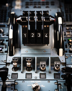 Four engine thrust levers on a widebody airliner flight deck