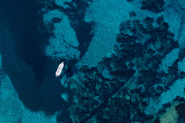 Aerial view of a sailing boat in the blue sea, Corsica, France.  © Pixelshop