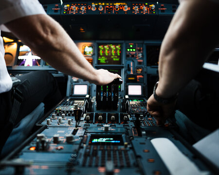 Hand on the four thrust levers of a widebody airliner flight deck