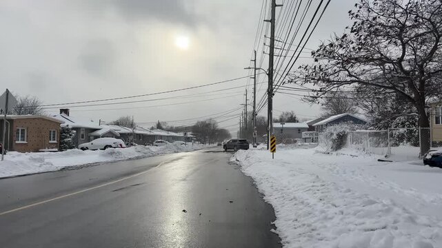 A serene winter day in Halifax, Nova Scotia, showcases snow-covered streets and glimmering sunshine, creating a peaceful atmosphere filled with charm and beauty