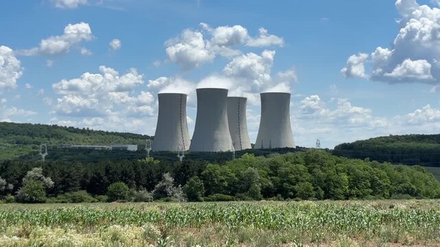 nuclear power plant background blue sky surface close up of cooling towers emitting steam industrial product concept of green energy, atomic station, electricity generation.