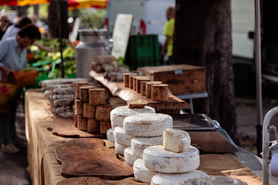Artisan cheese and food products selling at outdoor market in Provence, France