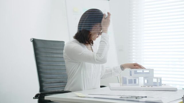Woman architect creating architectural model, designing housing project, developing urban planning, working on blueprints, constructing new buildings, shaping future cities