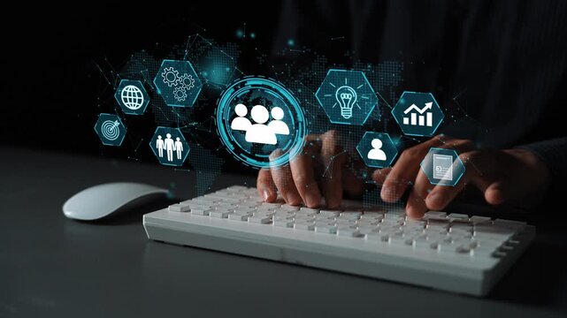Hands typing on a keyboard with digital icons representing technology, communication, and data analysis in a modern workspace environment. Entropy.
