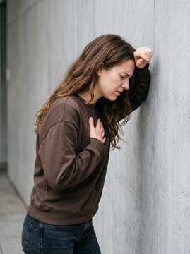 Reflective portrait of an emotional woman in an urban setting