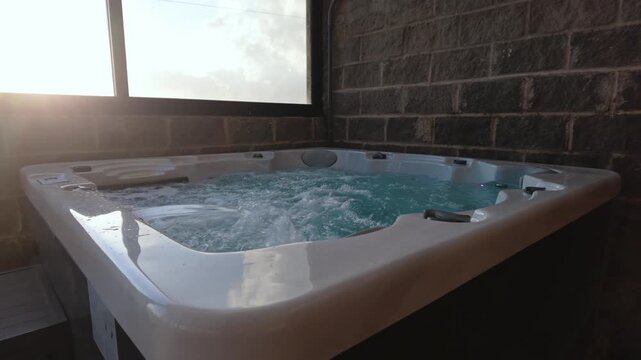 Outdoor hot tub jacuzzi bubbling at sunset