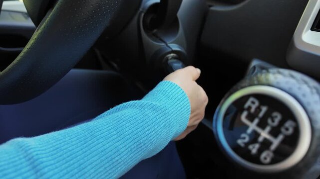 Woman Inserting Key into Ignition of Camper Van. Starting Motorhome Engine.