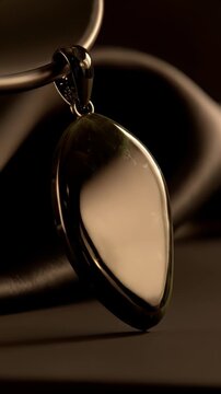 Extreme macro slow motion tracking, flawless glossy obsidian stone moving under warm light, 4k.