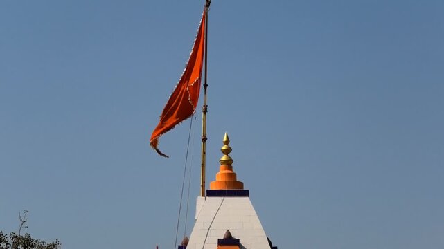 The colorful flag flying above the Bhalka Tirth Temple, Somnath, Veraval, Gujarat, India
