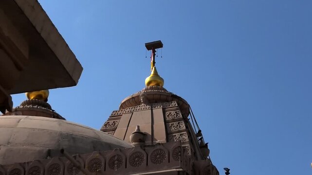 The colorful flag flying above the Bhalka Tirth Temple, Somnath, Veraval, Gujarat, India
