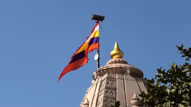 The colorful flag flying above the Bhalka Tirth Temple, Somnath, Veraval, Gujarat, India