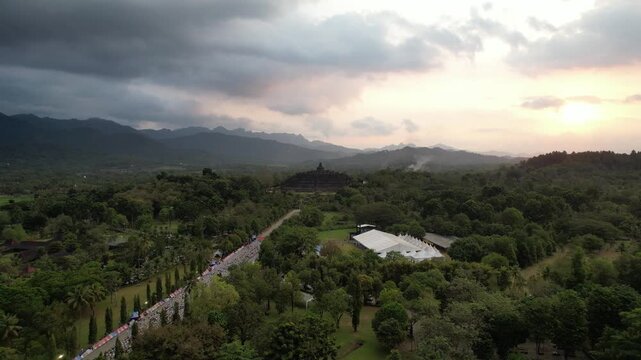 Epic Aerial View of Marathon Runners Heading Towards Borobudur Temple at Sunset