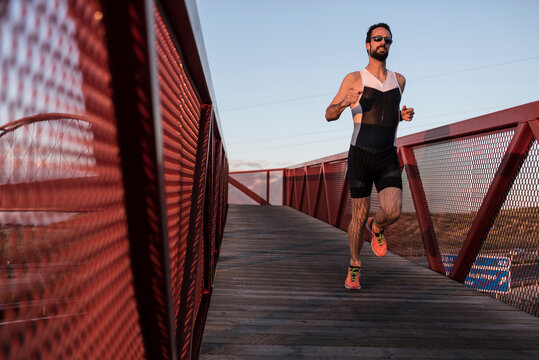 Runner in bridge training in sunset 