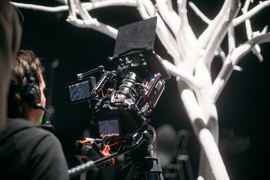 Professional film and video camera on the set in the pavilion. The crew, lighting equipment, filming equipment, and crew