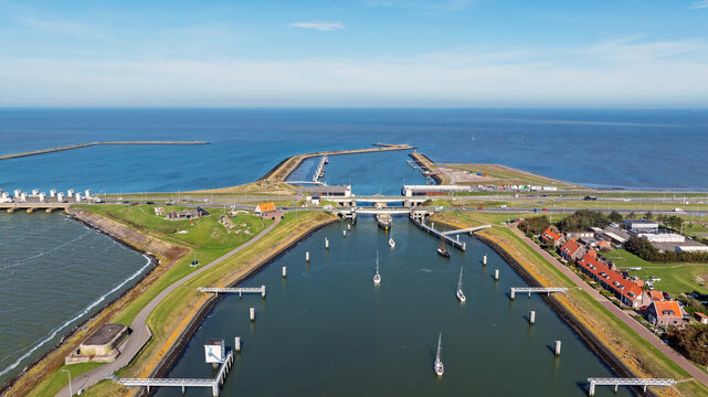 Sailing boats passing through sluices on a coastal dam in Europe
