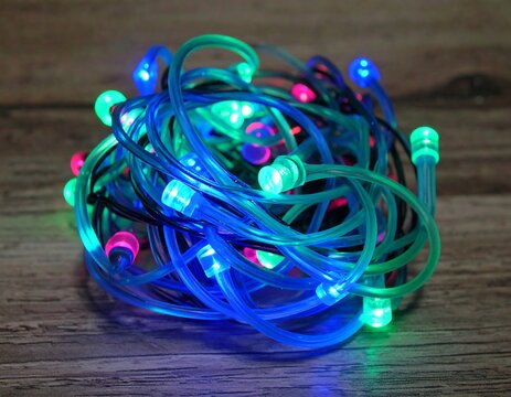Colorful LED string lights tangled on wood