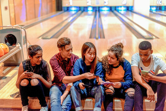 Friends enjoying bowling alley fun.