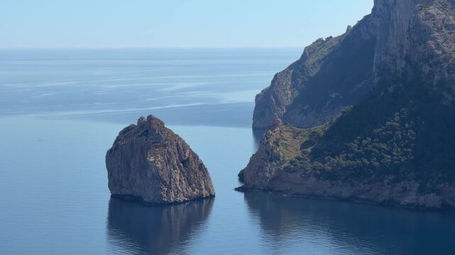 Iconic sea stack and rugged cliffs at Mirador Es Colomer, Mallorca, rising from calm Mediterranean waters and creating a breathtaking coastal landscape.