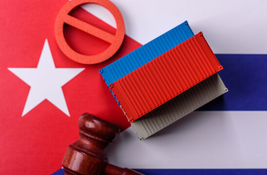 The cargo container ban on the Cuba flag as a conceptual backdrop. The cargo container embargo